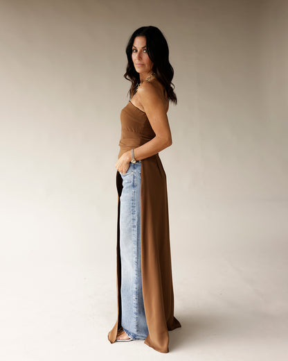 Brown sleeveless satin tunic with chain strap detail, styled over light wash jeans
