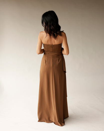 Brown strapless satin maxi dress with waist tie, back zipper, shown from behind
