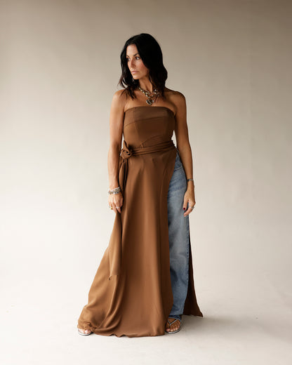 Brown strapless satin maxi tunic with waist tie, worn over blue jeans