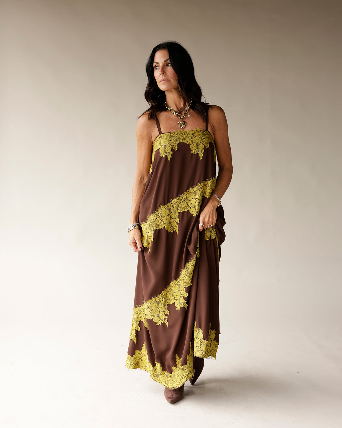 Brown maxi slip dress with yellow-green lace trim diagonal detail, spaghetti straps
