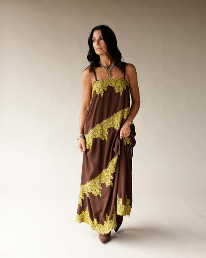 Brown maxi slip dress with yellow-green lace trim diagonal detail, spaghetti straps