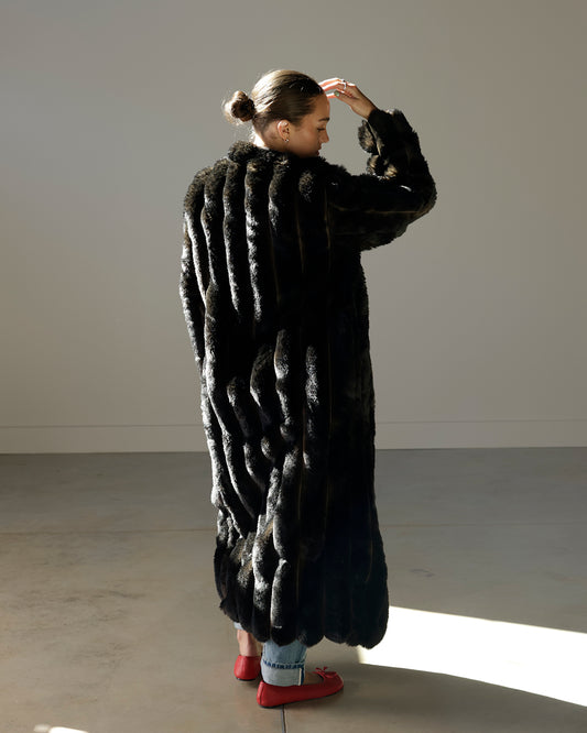 loucia black faux fur maxi coat featuring a plush textured exterior, oversized silhouette, long sleeves, satin-like lining and dramatic full-length design.