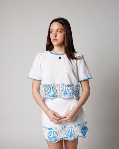white linen short sleeve shirt with crochet and seashell hem and blue trim detailing