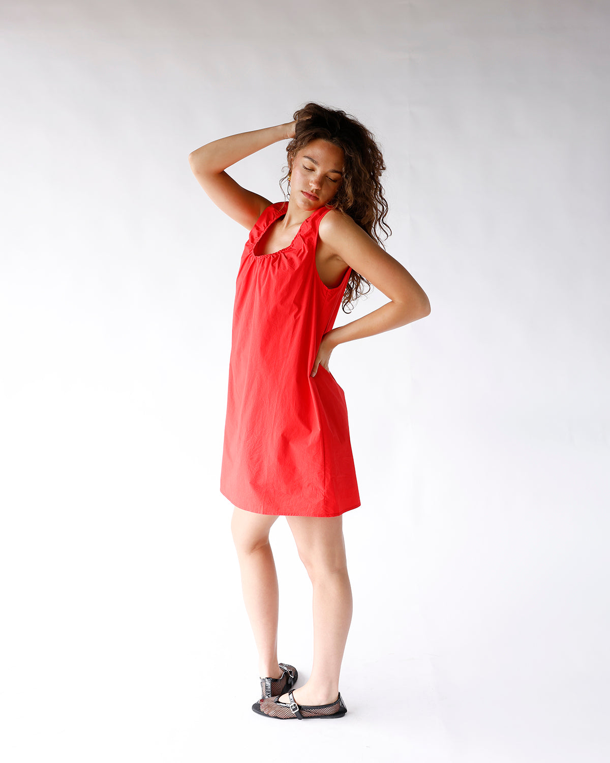 Red sleeveless mini dress with gathered neckline and relaxed A-line silhouette