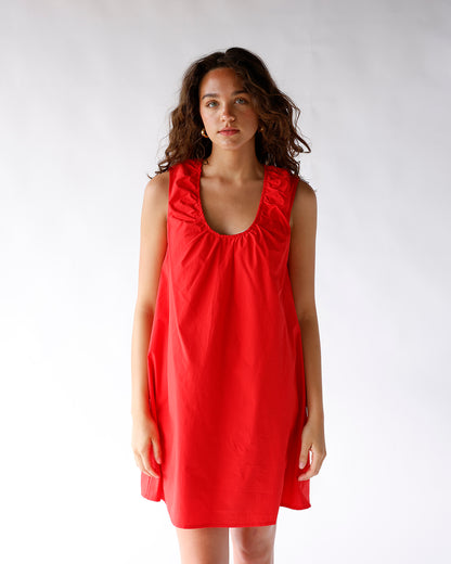 Red sleeveless mini dress with ruched neckline and relaxed A-line silhouette