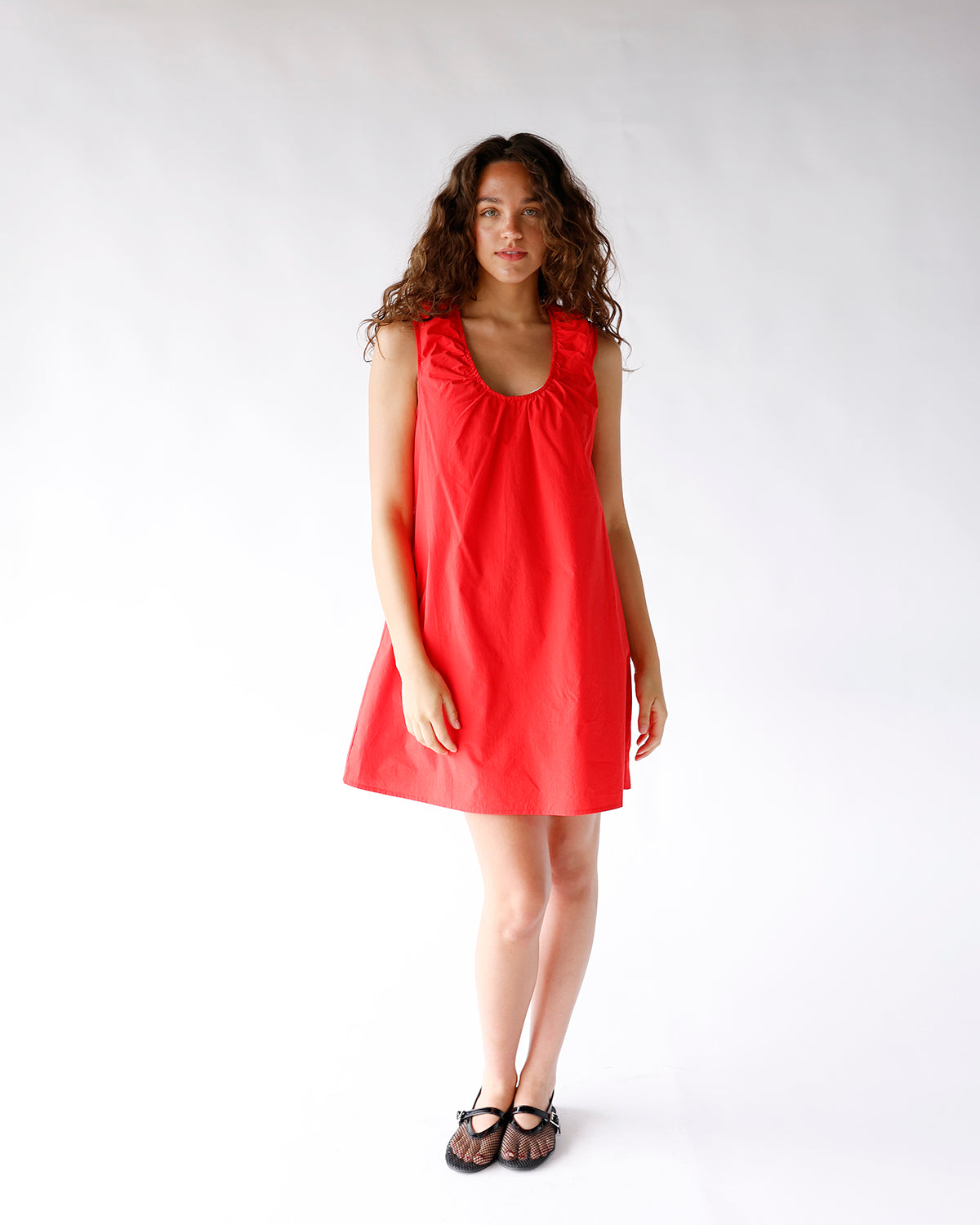 Red sleeveless mini dress with gathered scoop neckline and A-line silhouette