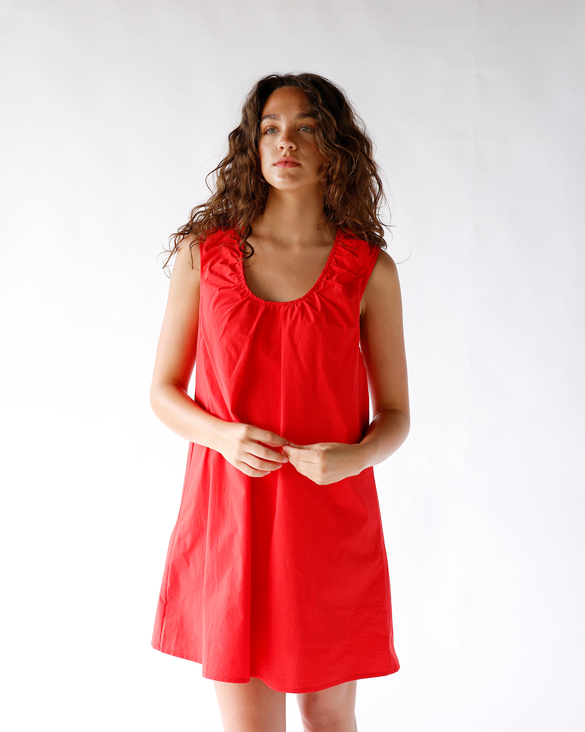 Red sleeveless mini dress with ruched scoop neckline and A-line silhouette