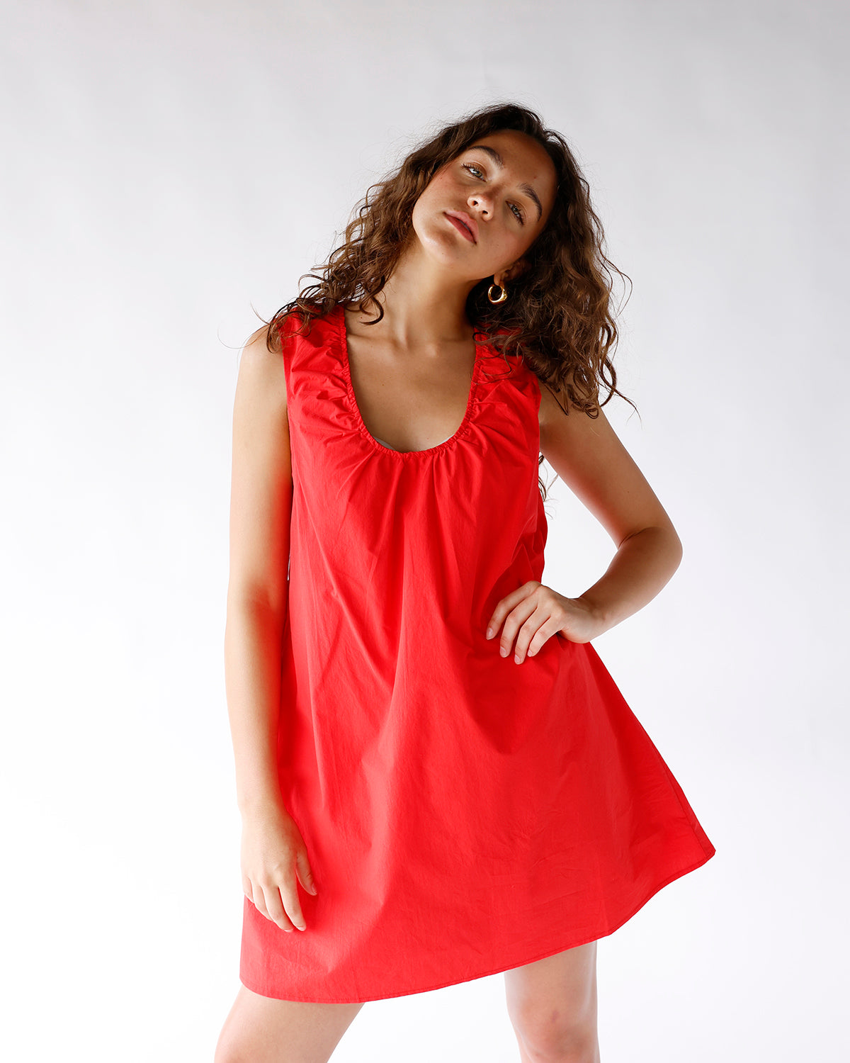 Red sleeveless mini dress with ruched neckline and A-line silhouette