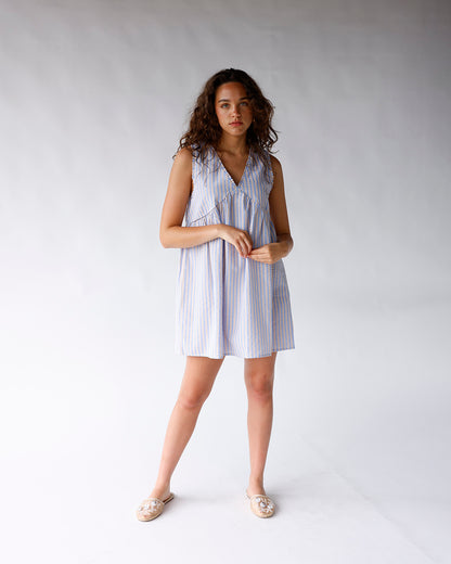 Blue and white striped sleeveless mini dress with V-neck and A-line silhouette