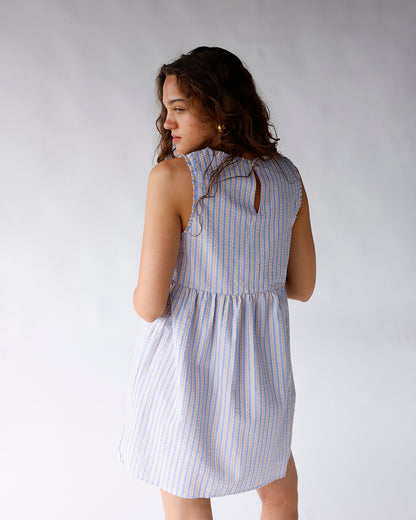 Blue and white striped sleeveless mini dress with tiered skirt and keyhole back