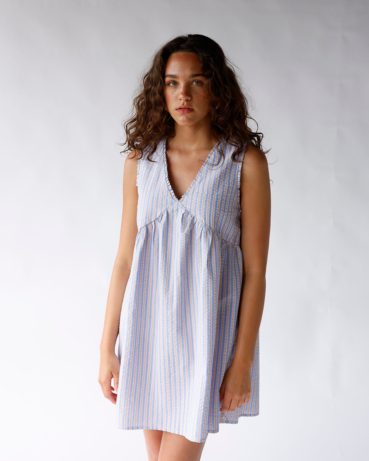 Sleeveless striped mini dress in blue and white with V-neck and gathered bodice