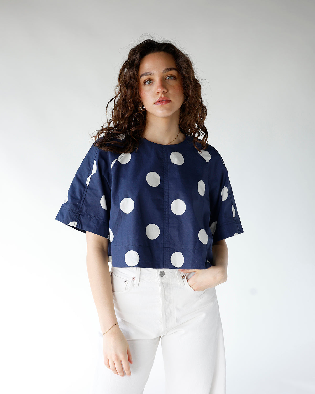 navy blue and white polka dot short sleeve back tie detail top
