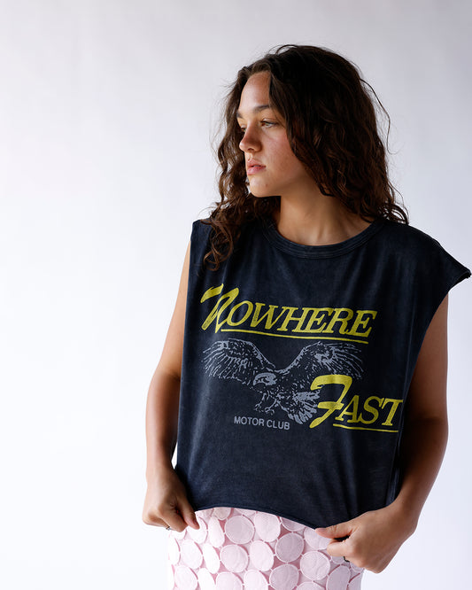 Turn heads in the Daydreamer Nowhere Fast Motor Club Cropped Muscle Tank. Featuring a distressed eagle graphic, acid-washed black finish, heavyweight cotton, and a relaxed boxy fit for effortless vintage style.