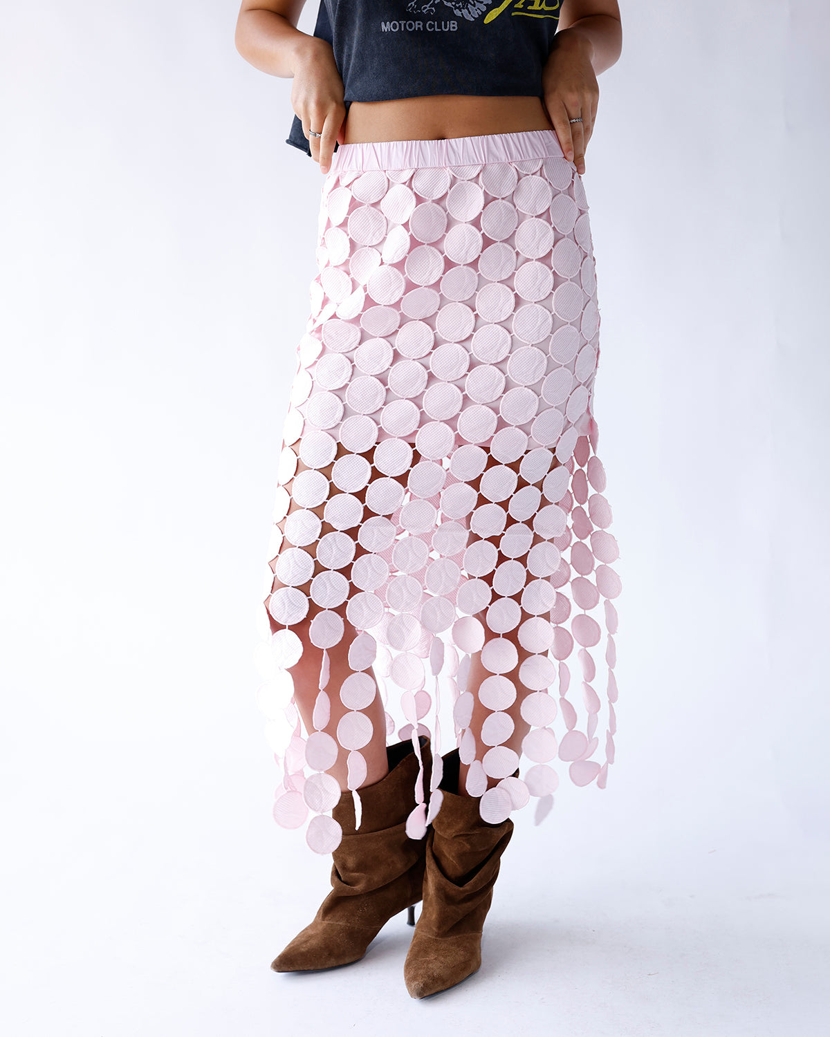 Shop our pink maxi skirt featuring a mini-length lining, sheer ankle-length overlay, allover pink circle design, and flowy hem. A feminine statement piece perfect for special occasions and elevated everyday style.