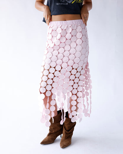 Shop our pink maxi skirt featuring a mini-length lining, sheer ankle-length overlay, allover pink circle design, and flowy hem. A feminine statement piece perfect for special occasions and elevated everyday style.