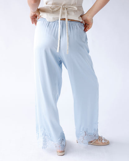 Light blue wide-leg pants with lace hem trim and elastic drawstring waist, back view