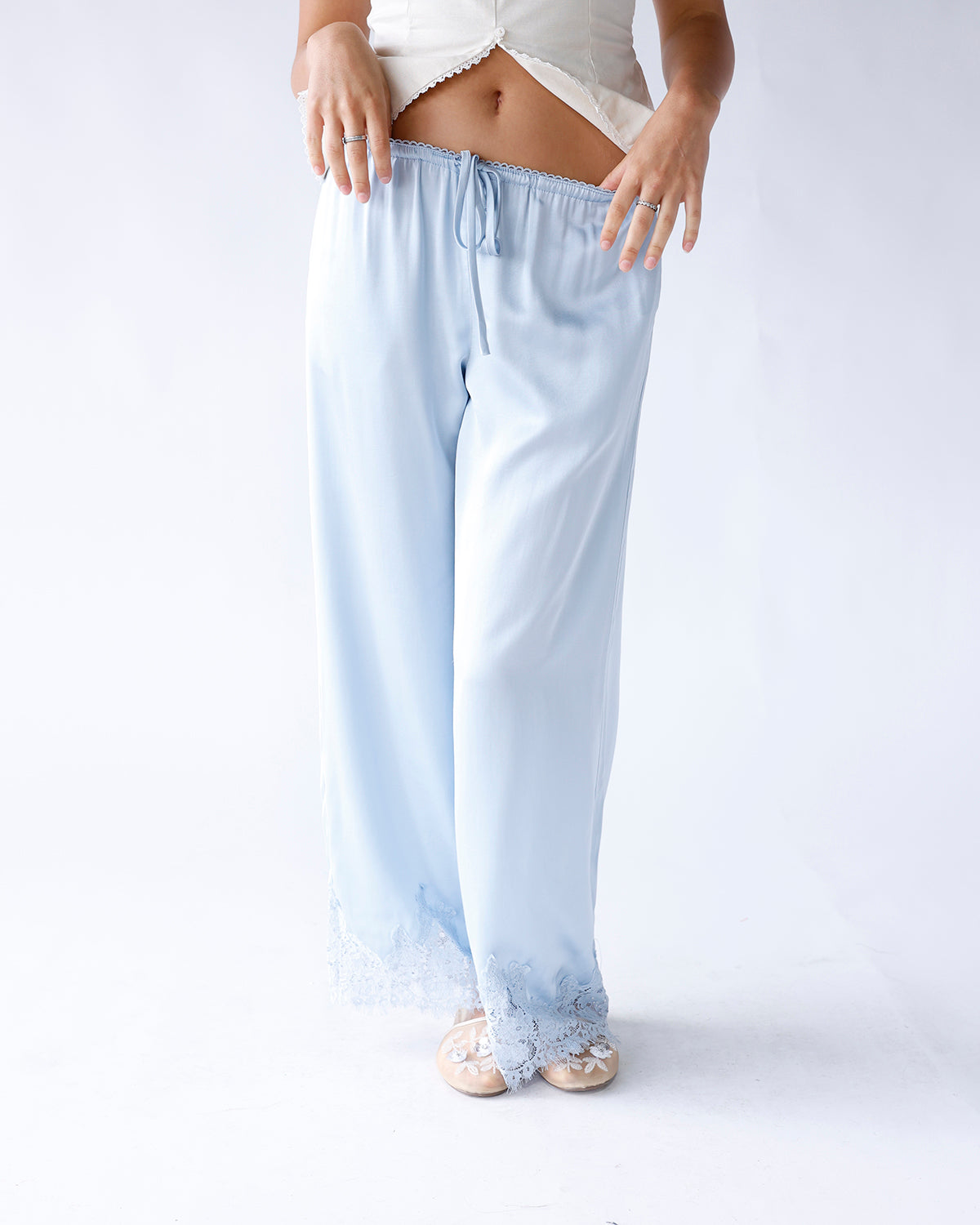 Light blue satin wide-leg pants with lace hem trim and drawstring waist
