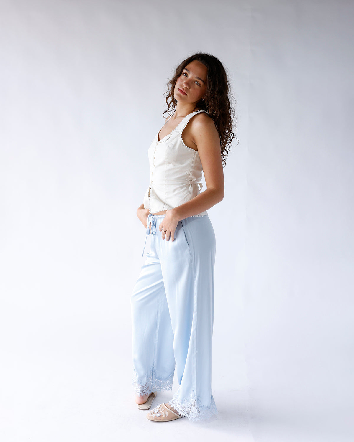 Light blue satin wide-leg pants with white lace hem trim and drawstring waist