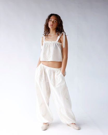 White eyelet embroidered wide-leg pants with elastic waist and side pockets