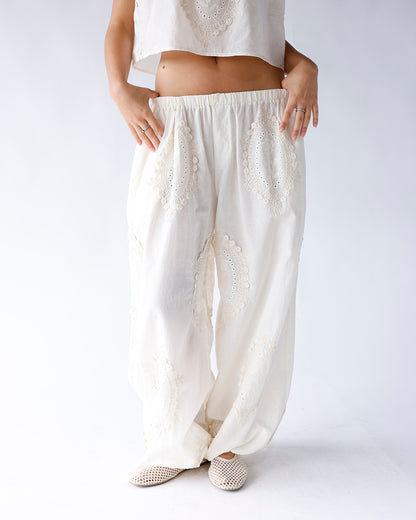White wide-leg pants with floral eyelet lace embroidery and elastic waistband