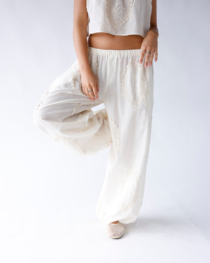 White wide-leg pants with beige lace medallion embroidery and elastic waistband
