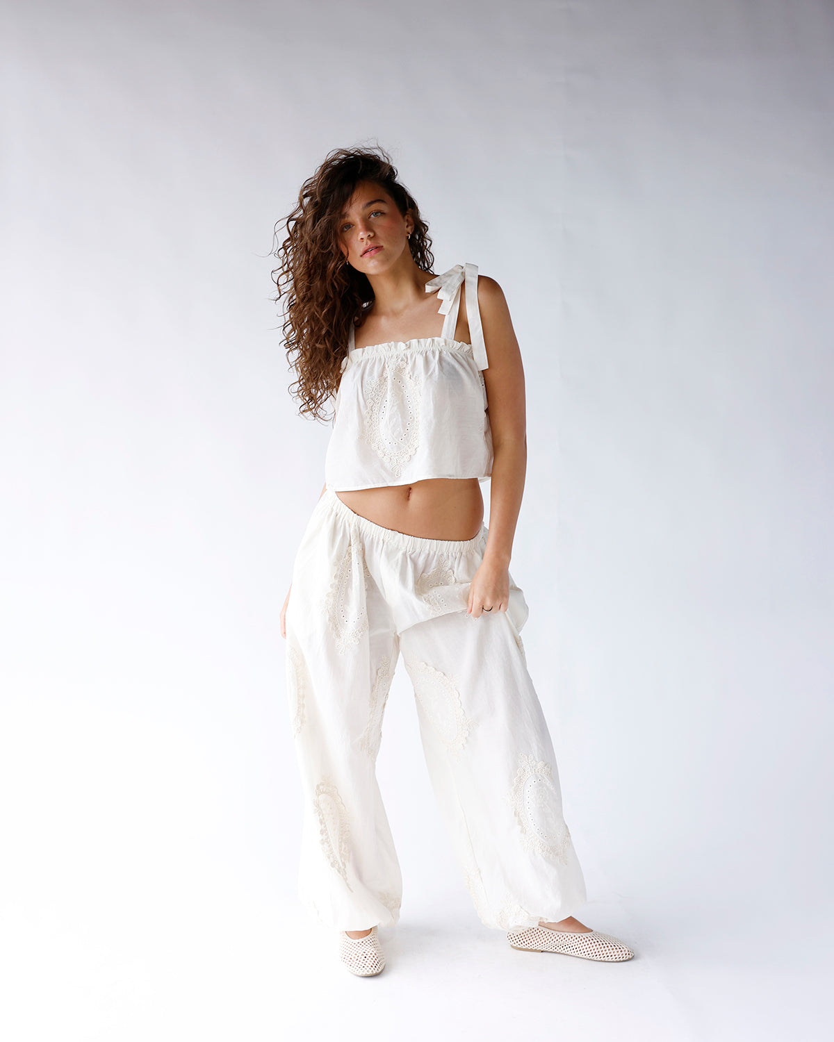White wide-leg dressy pants with eyelet embroidery detail and elastic waistband