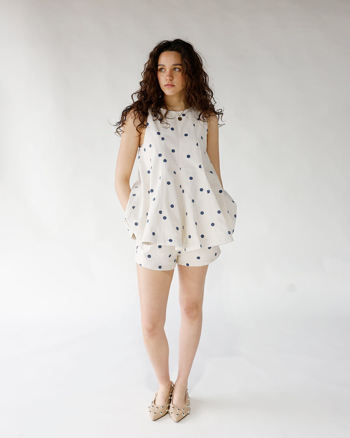 white with blue polka dot print sleeveless longline tank top and matching shorts set