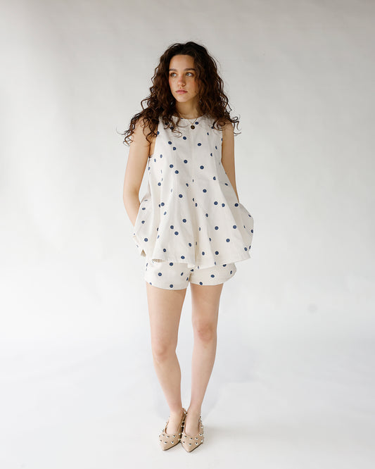 white with blue polka dot print sleeveless longline tank top and matching shorts set