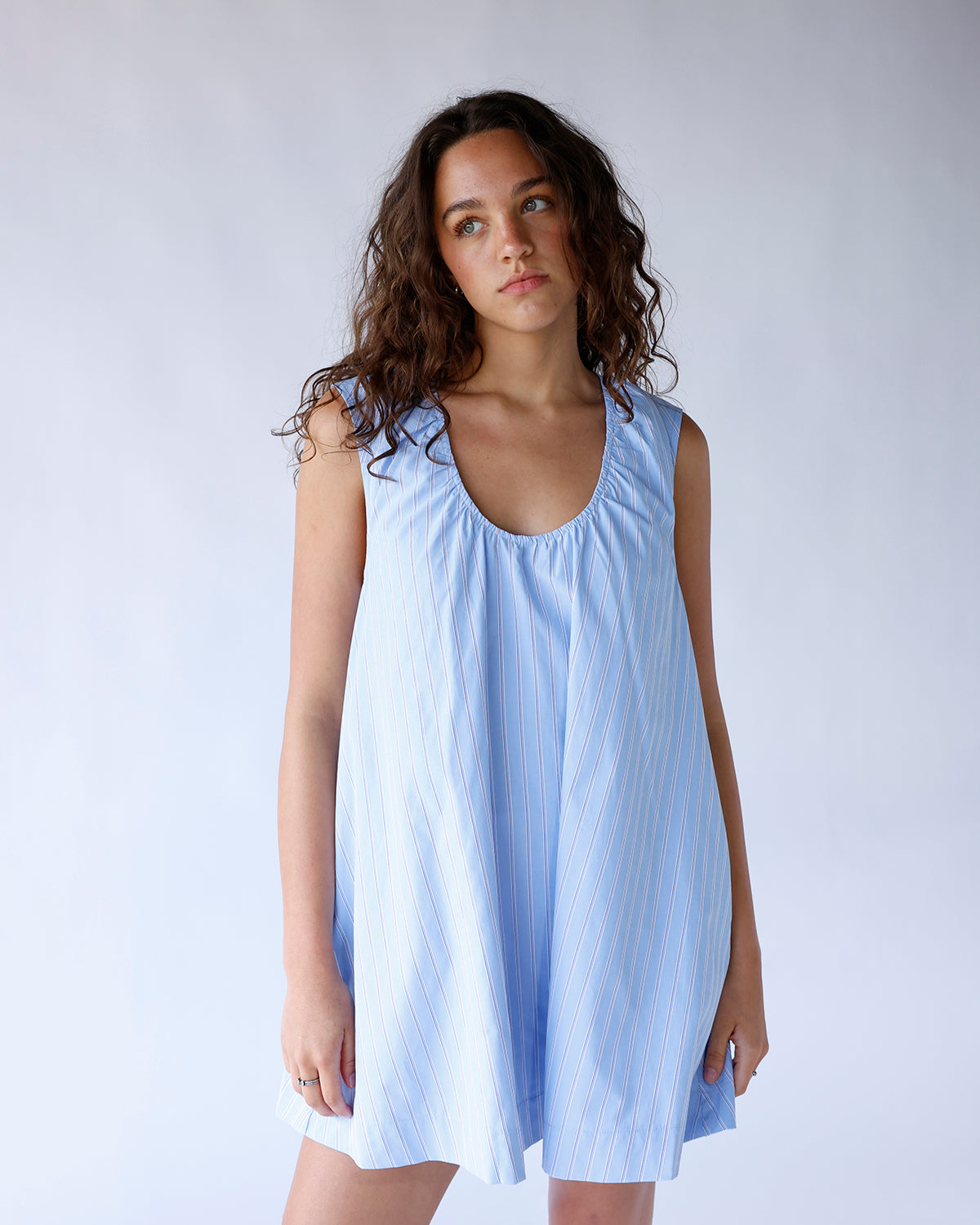 Light blue striped sleeveless mini dress with scoop neck and flowy silhouette