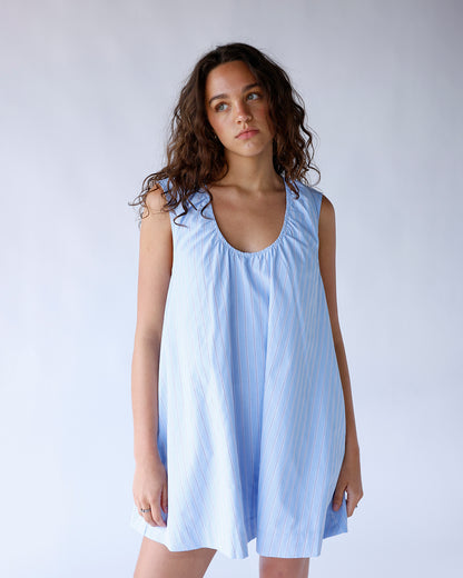 Light blue striped sleeveless mini dress with scoop neck and flowy silhouette