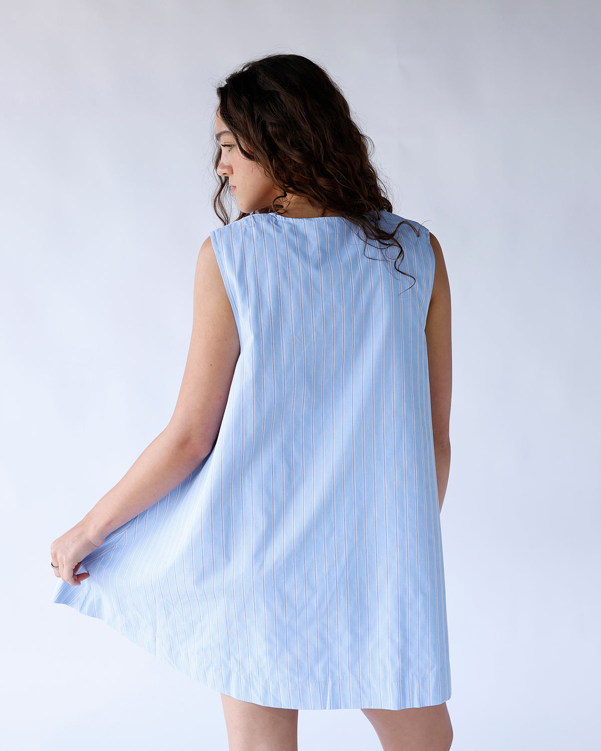 Sleeveless light blue striped swing mini dress shown from the back
