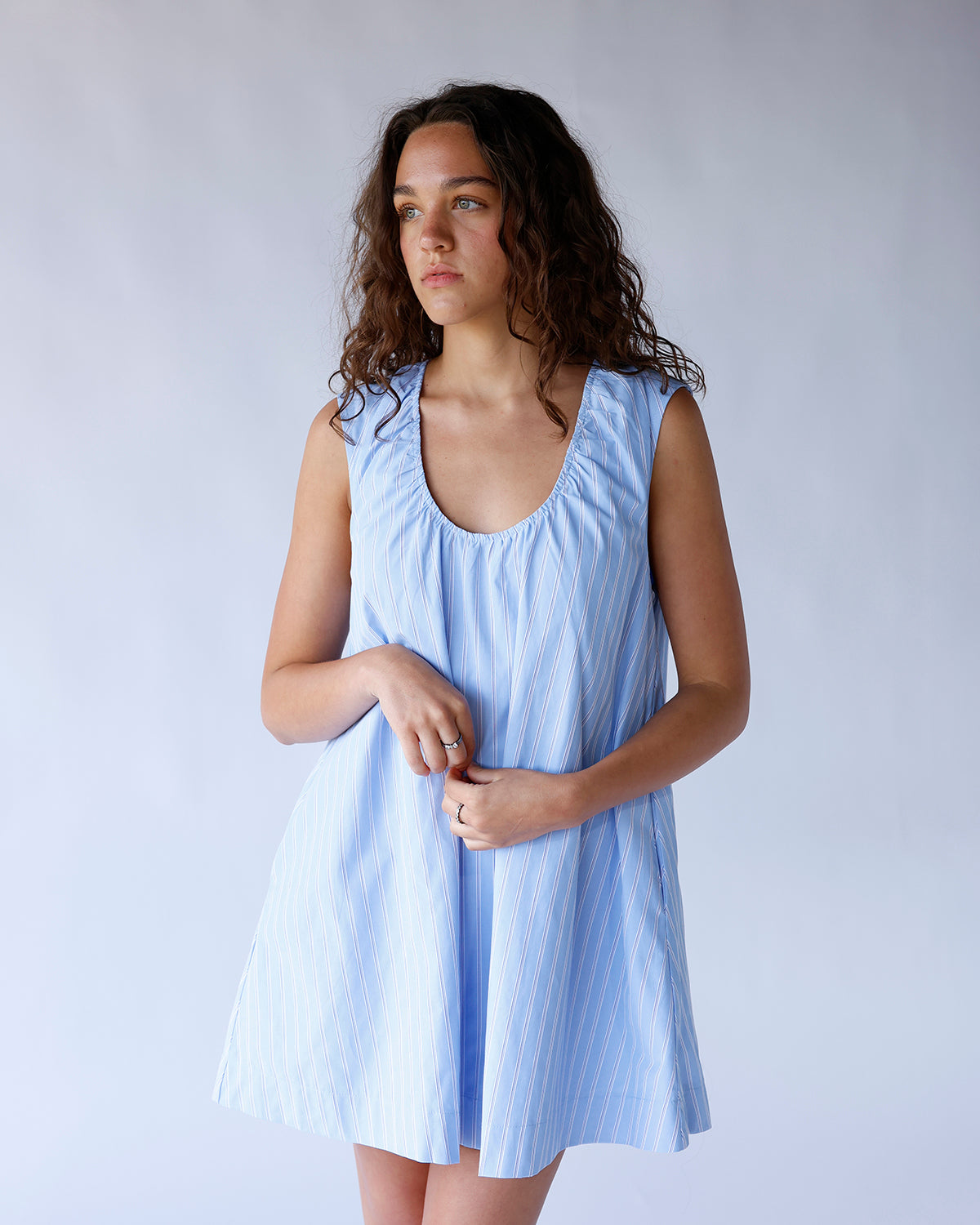 Light blue striped sleeveless mini dress with scoop neck and flared silhouette