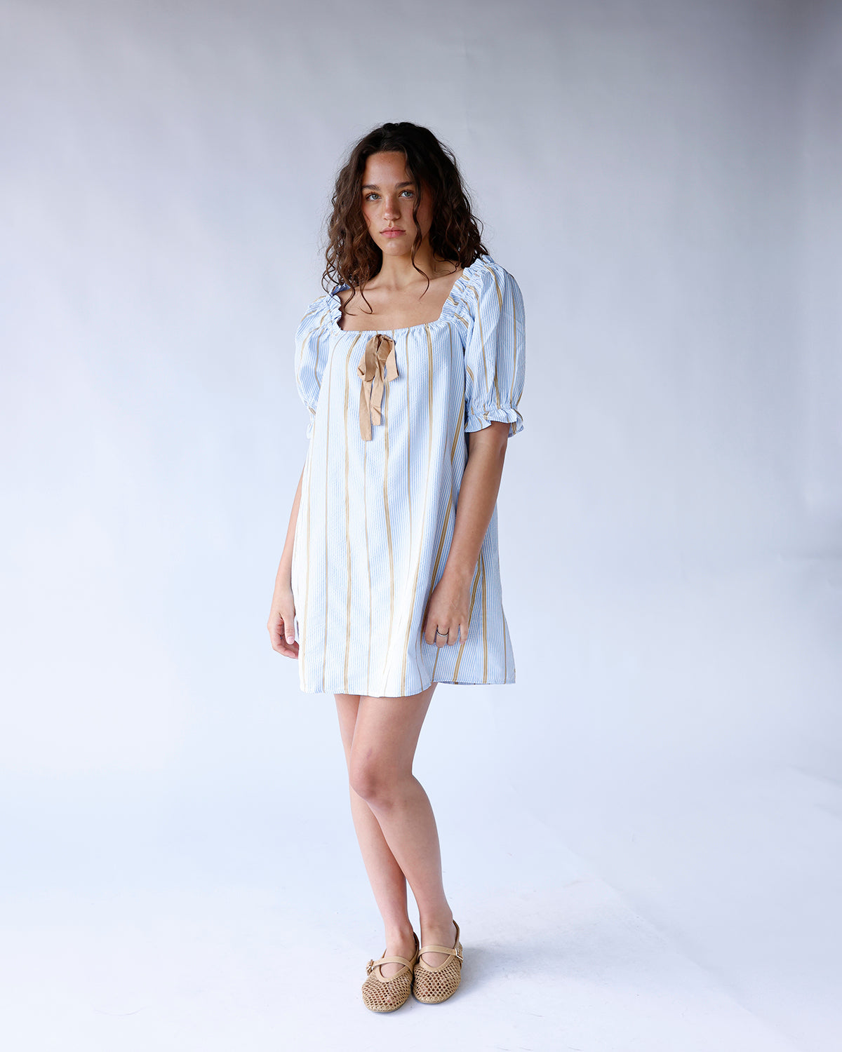 Blue striped square neck puff sleeve mini dress with tan ribbon tie