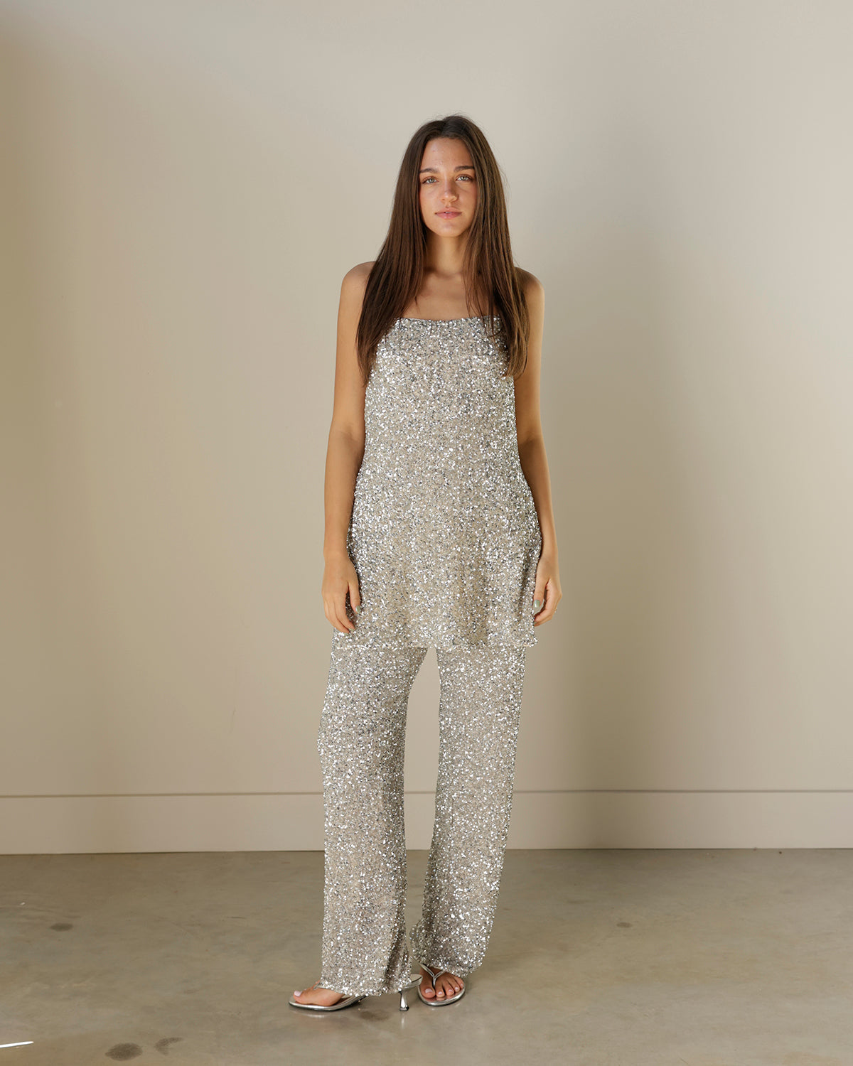 girl wearing matching sequin blouse tank top with sequin pants for the holidays and new years eve