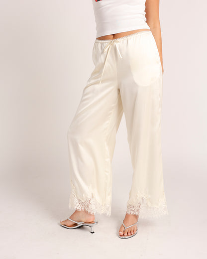 Cream satin wide-leg pants with lace trim hem and drawstring waist