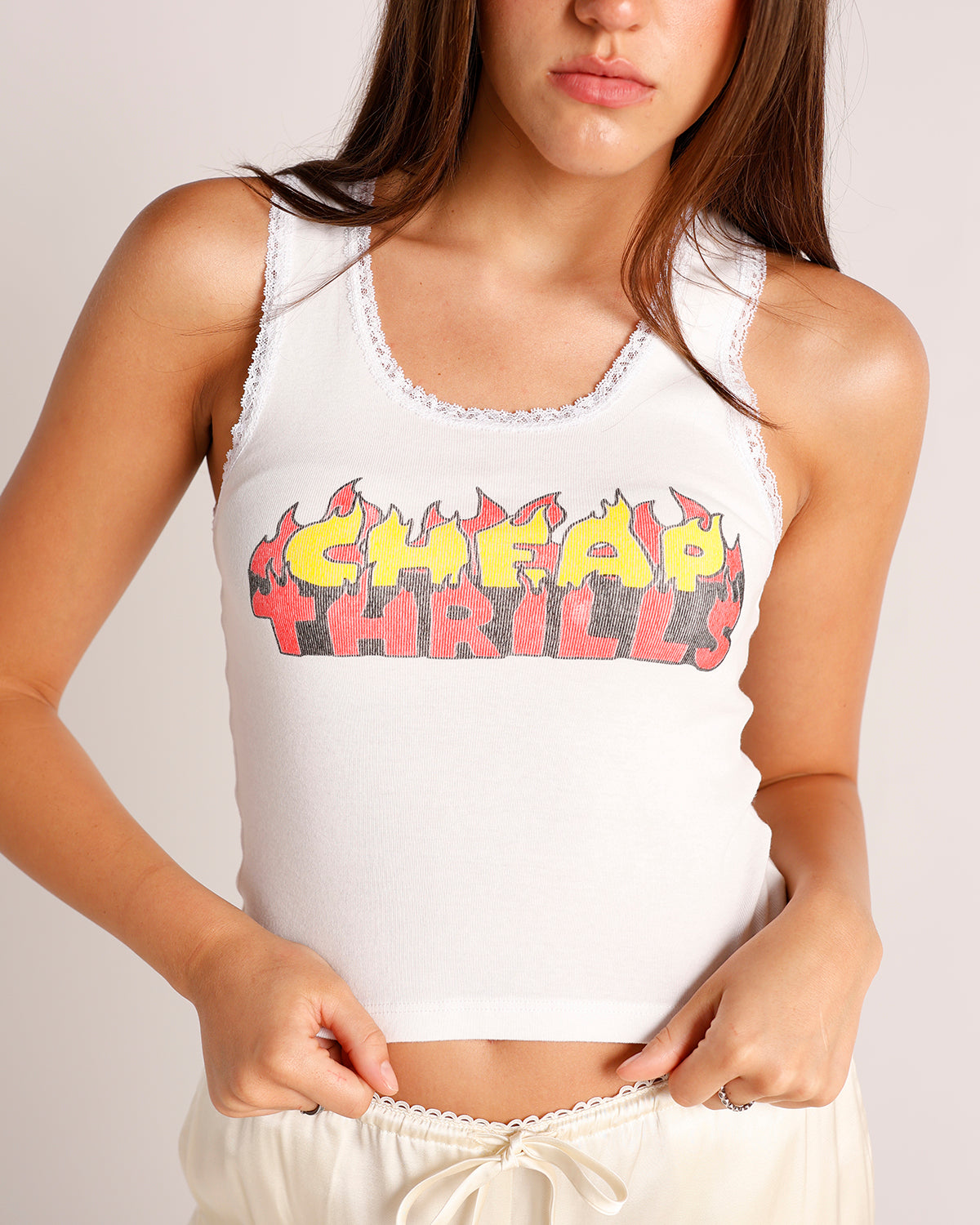 White ribbed lace-trim tank top with flame graphic print reading Cheap Thrills