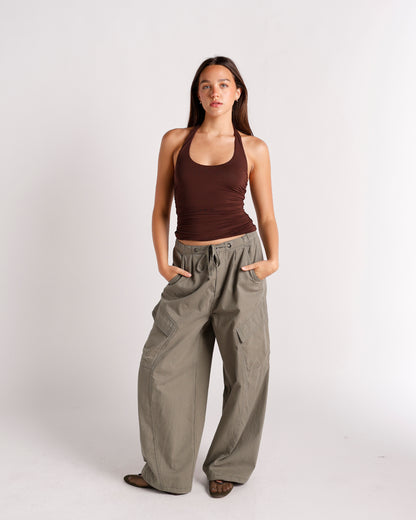 Dark brown ruched halter top with scoop neckline, worn with wide-leg cargo pants
