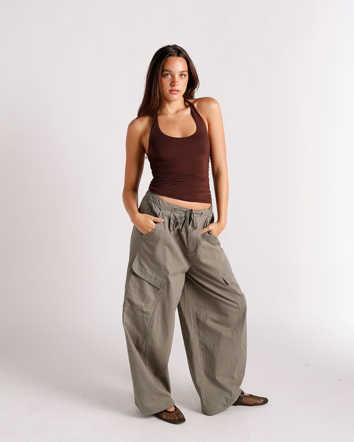 Oversized olive green cargo pants with wide leg, cargo pockets, and drawstring waist.