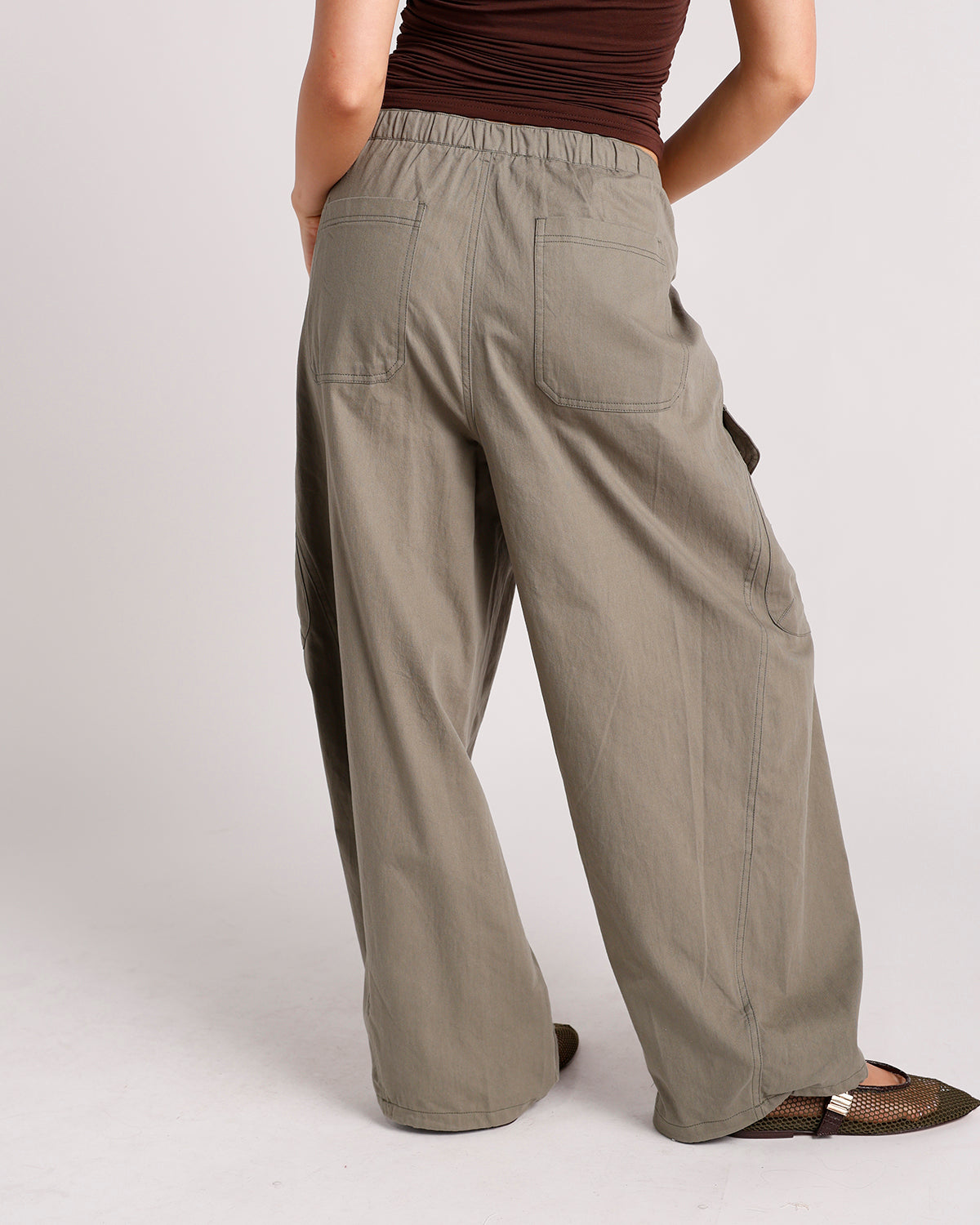 Wide-leg olive cargo pants with elastic waistband and patch back pockets