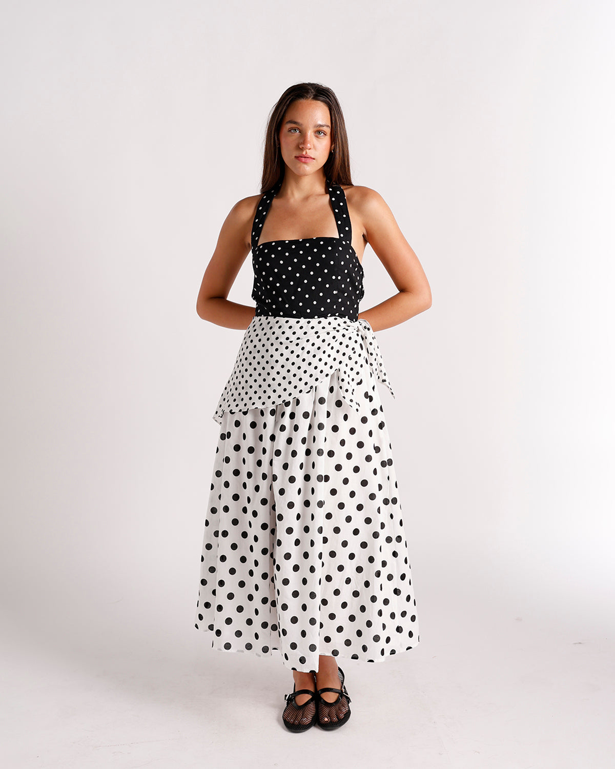 Black and white polka dot halter midi dress with tiered skirt and bow detail