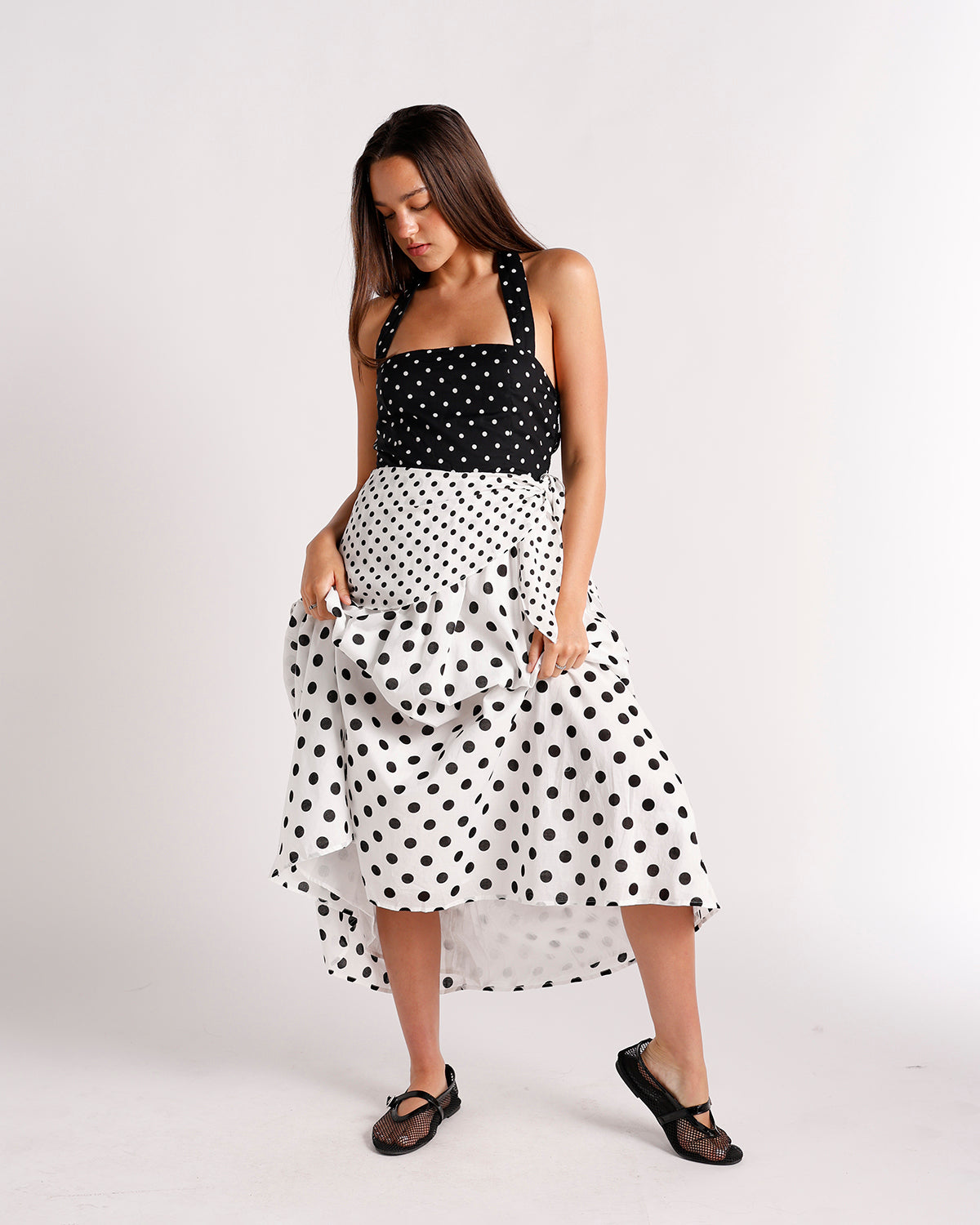 Black and white polka dot midi dress with ruffled skirt and halter straps