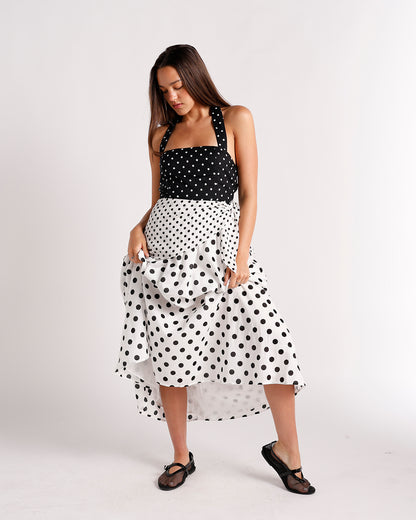 Black and white polka dot midi dress with ruffled skirt and halter straps