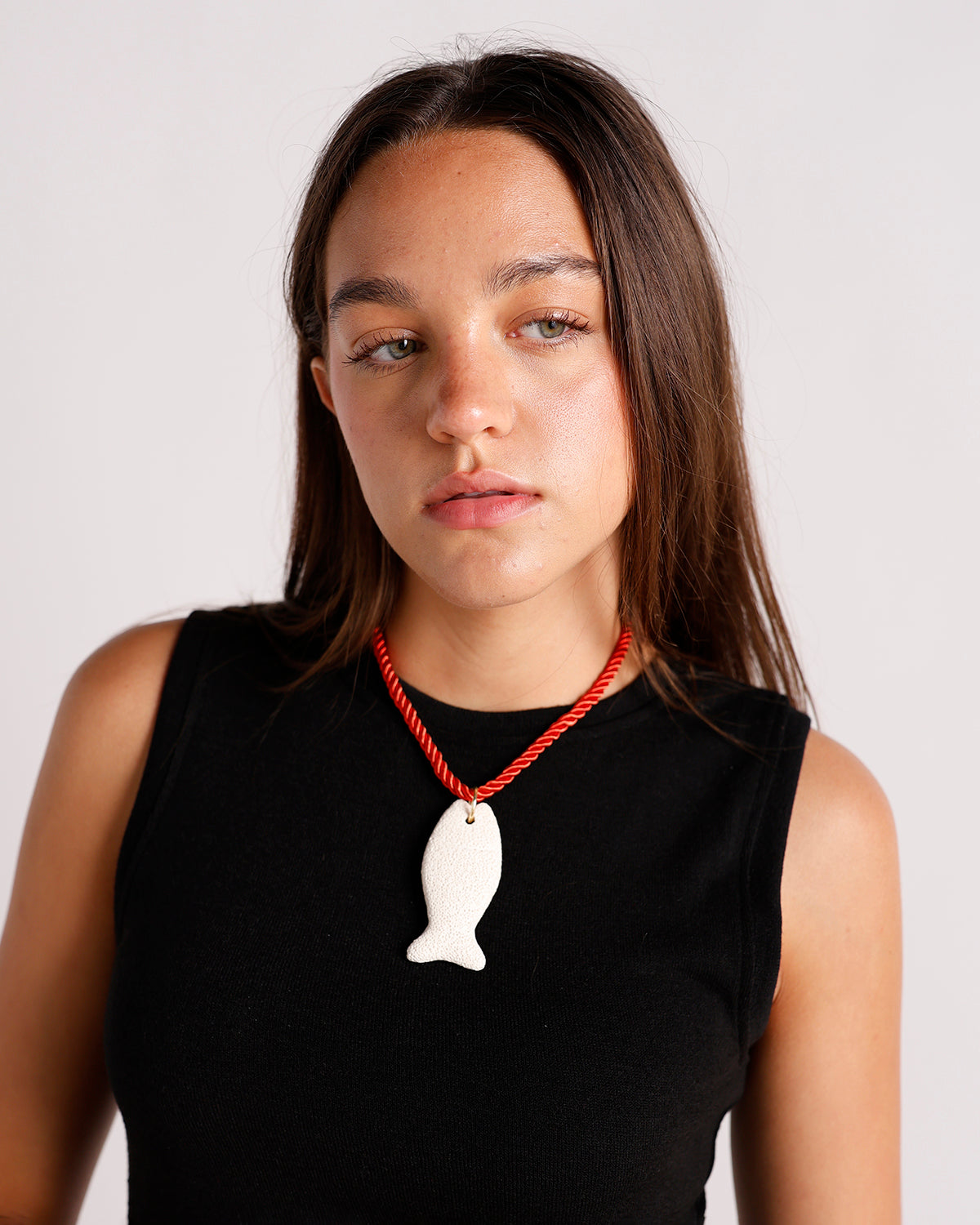 lava stone fish pendant necklace on red twisted rope cord