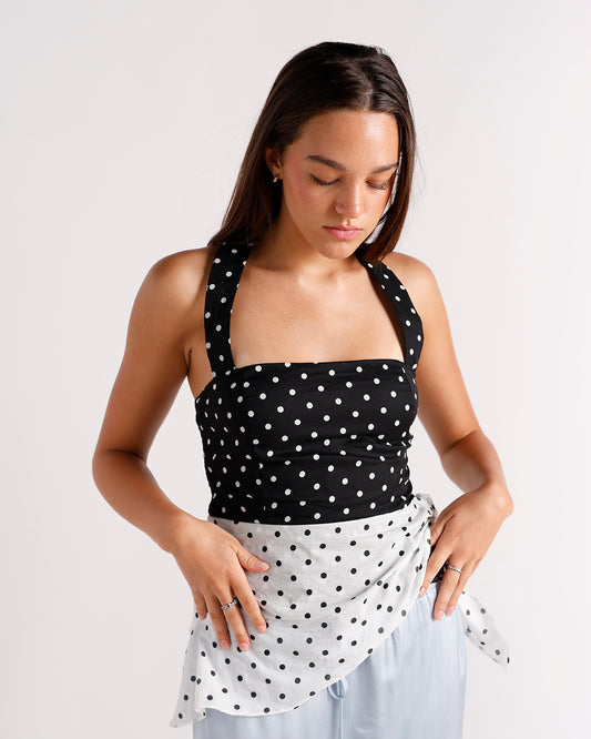 Black and white polka dot halter top with tie detail at waist