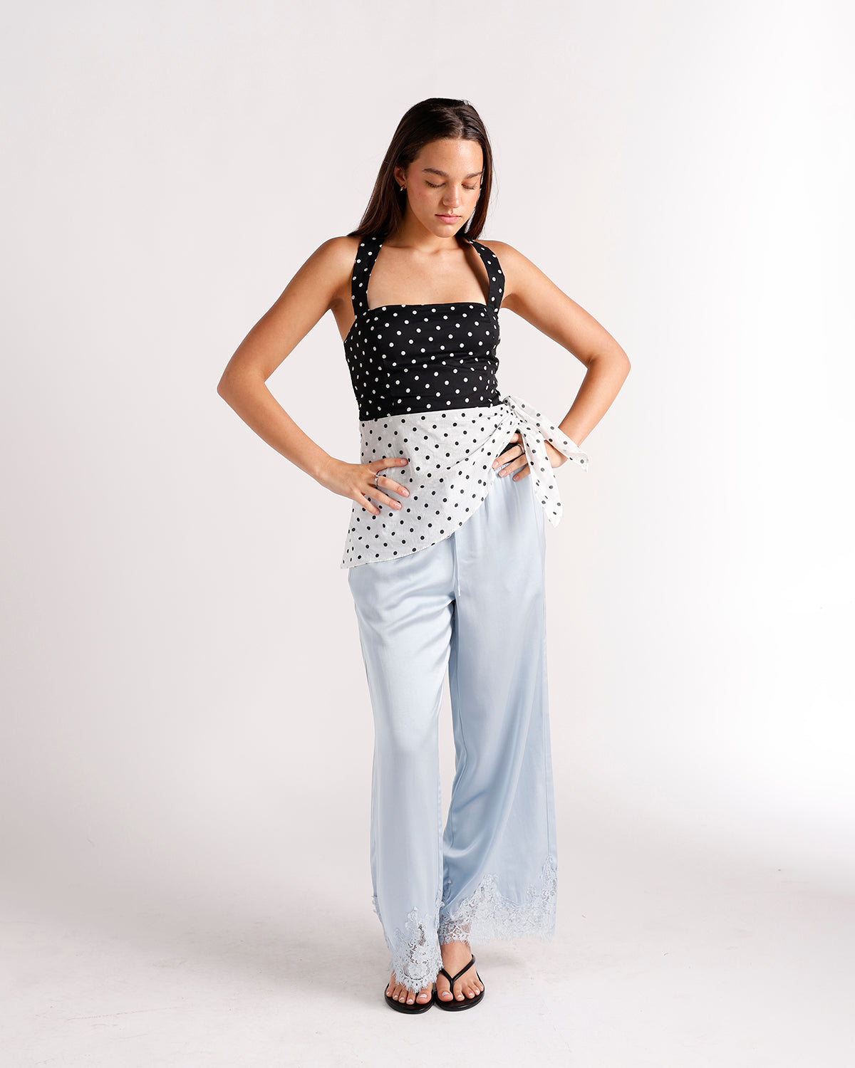 Black and white polka dot halter top with tied wrap detail at waist