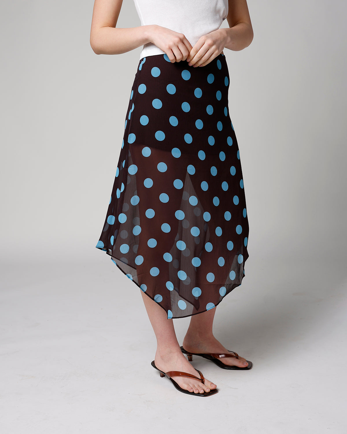 Brown chiffon midi skirt with blue polka dots, asymmetrical hem, worn with white top