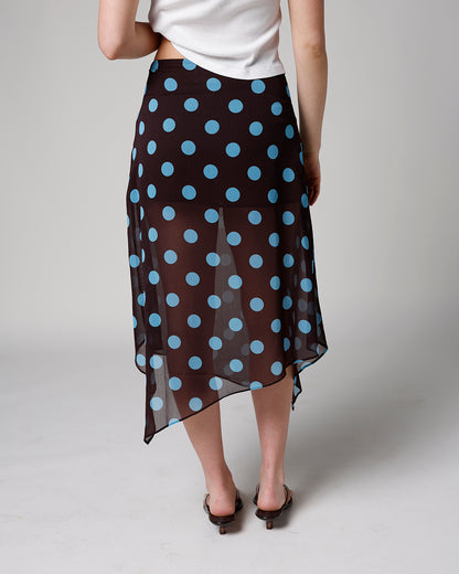 Black sheer midi skirt with large blue polka dots and asymmetrical hem