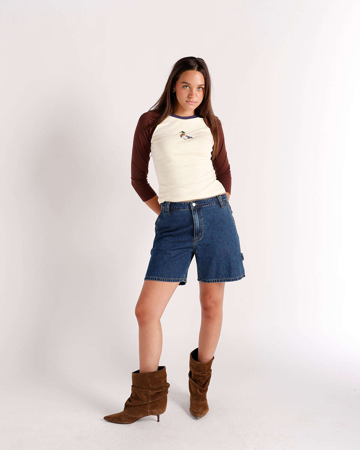 Cream and brown raglan long-sleeve top with small duck embroidery on chest.