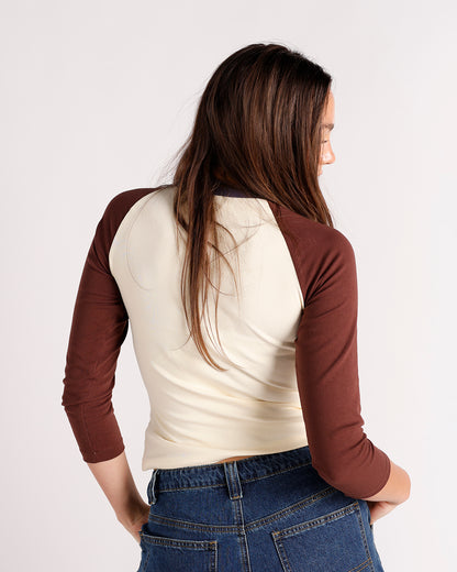 Cream and brown raglan three-quarter sleeve crop top, back view, paired with jeans.