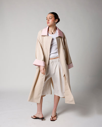 beige trench coat with removable light pink collar and cuffs